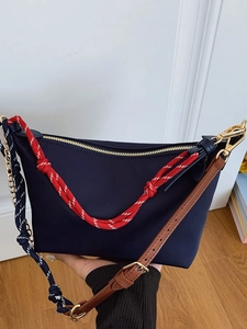 Navy nylon tote bag with nautical rope straps and brown leather shoulder strap handle