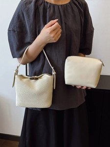 Two-piece beige straw bucket bag set with woven design and wooden buckle closure