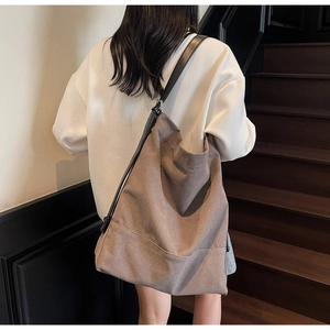 Detailed view of the taupe canvas bucket bag showing its large capacity and soft texture