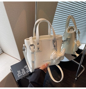Gros plan du sac seau blanc en similicuir avec poignée et texte mode sur le devant