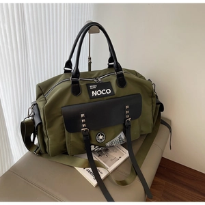 Close-up of army green travel bag featuring leather handles and NOCO brand logo