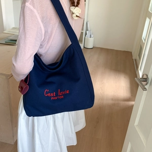 Deep blue canvas tote bag featuring red C'est lavie letter embroidery and wide shoulder strap