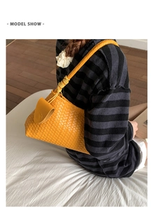 Detail showing the intricate yellow woven leather texture and knotted shoulder strap