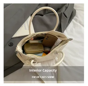 Detailed interior view of creamy white bucket bag showing large capacity for essentials