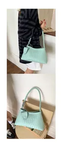 Close-up of mint green woven leather bucket bag with signature braided shoulder strap