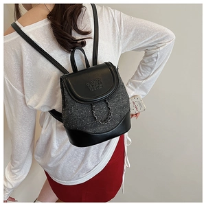 Close-up of the small backpack with chain detail and embossed enjoy chan 2015 logo