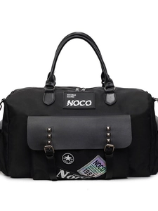 Large black canvas travel duffel bag with NOCO branding and stylish metal rivets