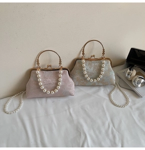 Close-up of vintage embroidery silk bags with pearl handles and metal frame closure