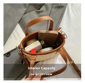 Detail view of mini canvas bucket bag interior showing capacity for phone and cosmetics