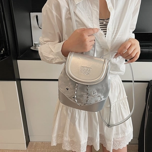 Silver metallic mini backpack with engraved detail and stylish chain strap for women