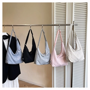 Detailed display of high-capacity nylon crescent tote bags in five versatile colors