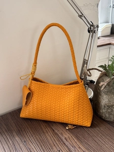 French style woven orange hobo shoulder bag with a minimalist bucket shape design