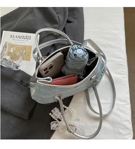 Detail showing large capacity interior of blue sequin bucket bag with accessories