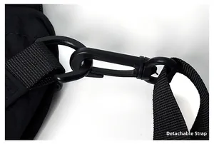 Detail of detachable shoulder strap with swivel hook and D-ring on black nylon backpack