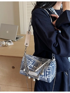 Striped canvas cylinder shoulder bag with silver chain and pearl pendant charms