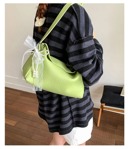 Lime green faux leather dumpling bag with white lace bow and pearl bead accents