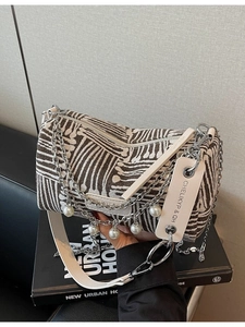 Chic cylinder canvas pillow bag with geometric pattern and silver chain handle