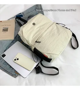 Size comparison of light nylon backpack with iPad and phone for scale visualization