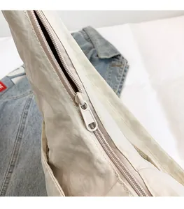 Detailed close-up of smooth color-matched zipper on a lightweight nylon tote bag