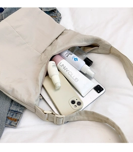 Large capacity beige nylon tote bag showing interior space for tablet and cosmetics