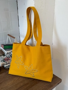 Large yellow canvas tote bag with metal rivet star patterns for summer daily commuting