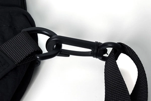 Detail of durable black nylon shoulder strap with matte black spring hook and D-ring connector