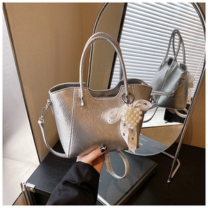 Silver metallic bucket bag with pearl heart pendant and textured pleats detail