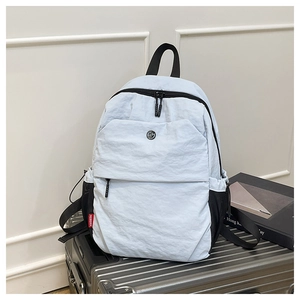 Detail of light blue waterproof travel backpack on luggage with red side tag and GM logo