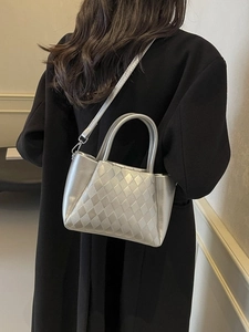 Silver quilted crossbody bucket bag with metallic finish and detachable strap