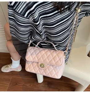 Fashionable quilted crossbody bag with gold chain strap shown in a real-life setting