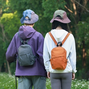Outdoor waterproof mini nylon backpack and sun hat detail view in natural light
