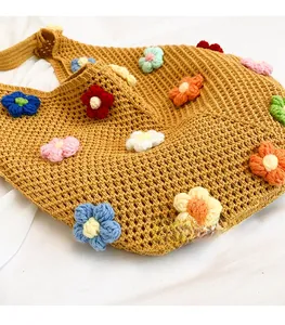 Detailed macro view of caramel crochet tote bag with colorful 3D knitted flower patterns
