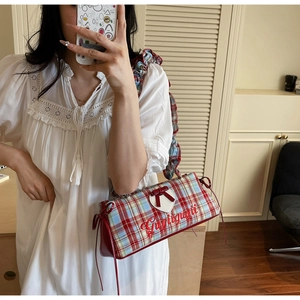Close-up of red plaid handbag with heart applique, bow knot and ruffled handle details
