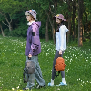 Outdoor lifestyle shot of a durable nylon backpack with multiple pockets in nature