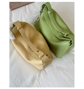 Detail of lychee pattern leather bags with elegant pearl charm and lace decoration
