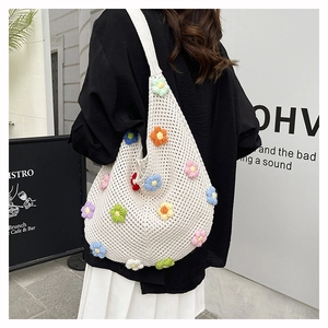 Detail of crochet tote bag featuring colorful 3D flowers and hollow knit texture