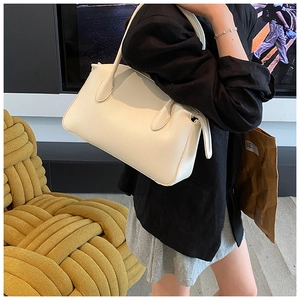 Detail of off-white lychee texture leather tote bag with elegant handles and zipper