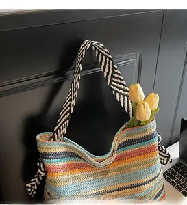 Detailed macro view of vibrant multi-color striped woven straw bag with geometric strap