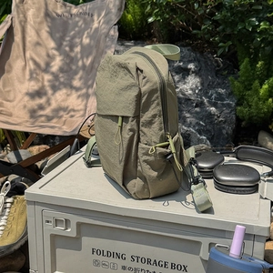 Detail of army green nylon backpack with water-resistant texture in outdoor camping setting