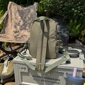 Detail of army green outdoor crossbody bag in nylon with adjustable strap and buckles