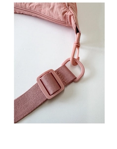 Détail du sac en nylon rose montrant le crochet de sangle et le zip en résine