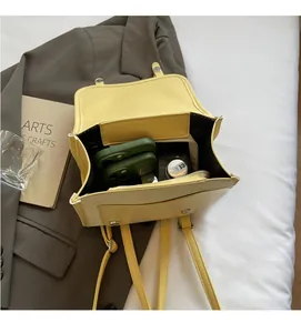 Top view of yellow leather backpack interior showing spacious storage with inner pocket