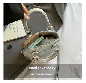 Macro view of silver shell bag interior capacity showing phone and makeup items