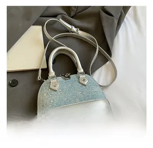 Macro shot of light blue sequined shell bag with silver leather trim and rivet details