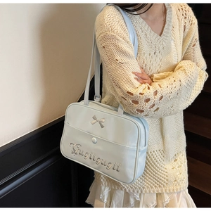 Detail of light blue JK style shoulder bag with silver bow and letter embroidery