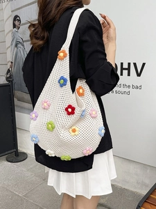 White crochet tote bag with colorful 3D knitted floral decorations for beach style