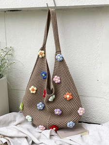 Handmade crochet tote bag with colorful 3D flower knit patterns on a brown mesh background