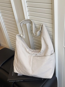 Large off-white nylon crescent tote bag with wide strap for stylish daily commuting