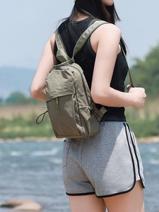 Lightweight olive green nylon mini backpack with drawstring pockets for outdoor hiking
