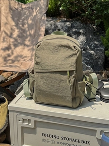Olive green outdoor nylon backpack with waterproof texture for camping and hiking